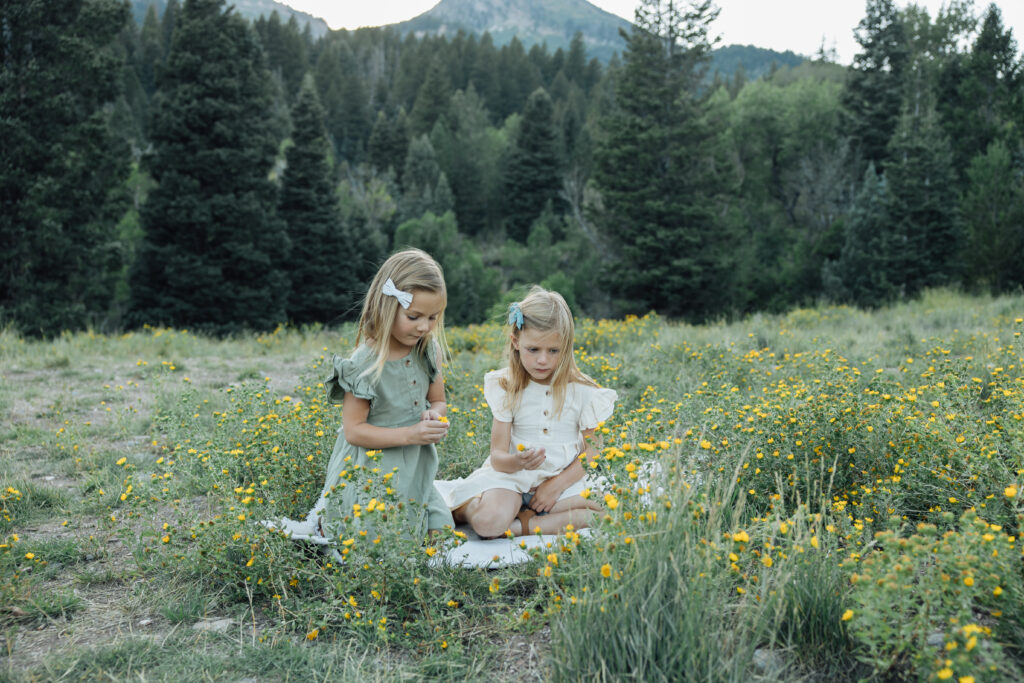 two sisters playing in the mountains in a candid family photograph