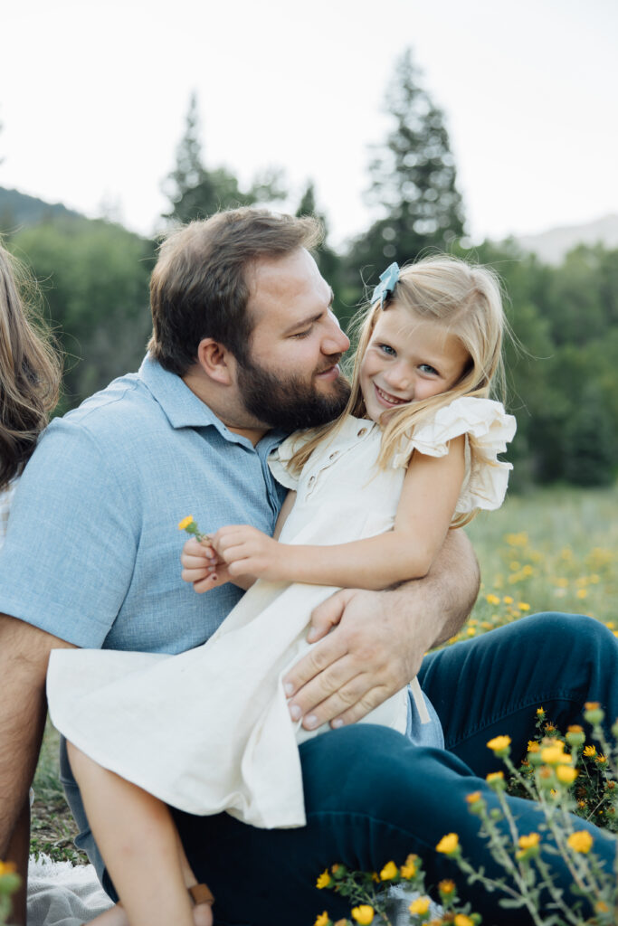 Father and daughter playing in the mountains in a candid family photo