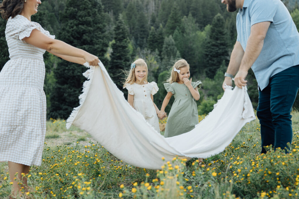 family plays in the mountains for candid family photographs