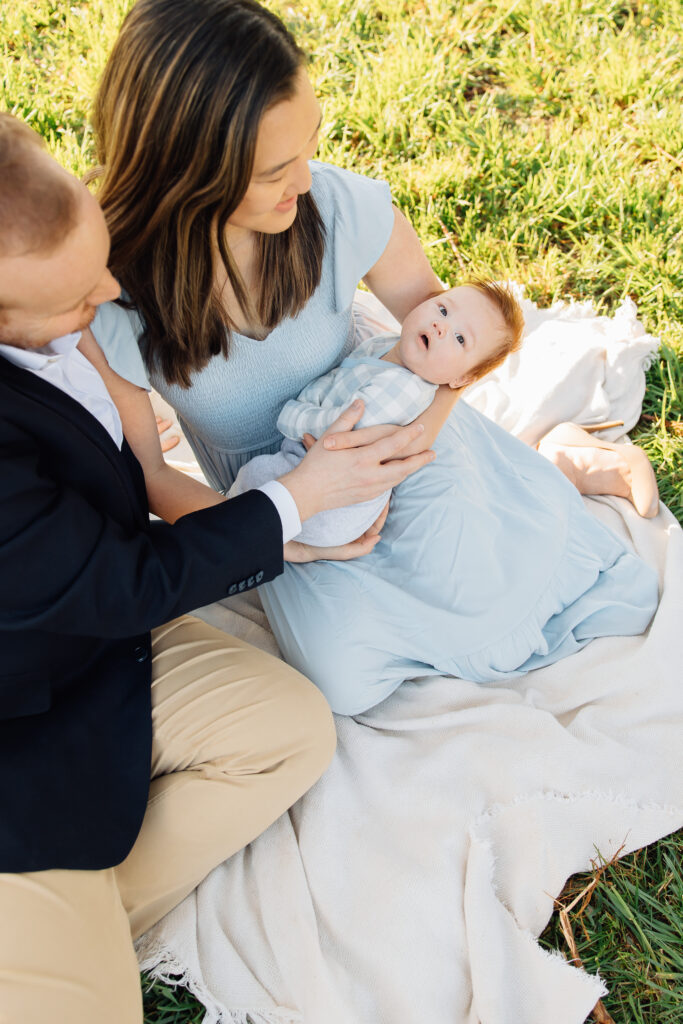 Baby smiles at blossoms at a spring mini session in Fruit Heights, Utah
