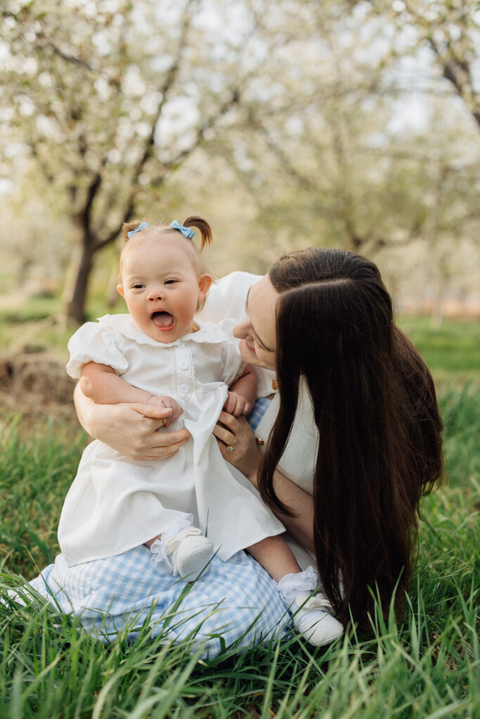 Mother and baby smile at spring family photo session
