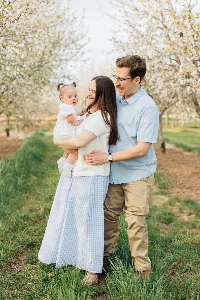 Family smiles at spring family photo session at Rowley's Red Barn