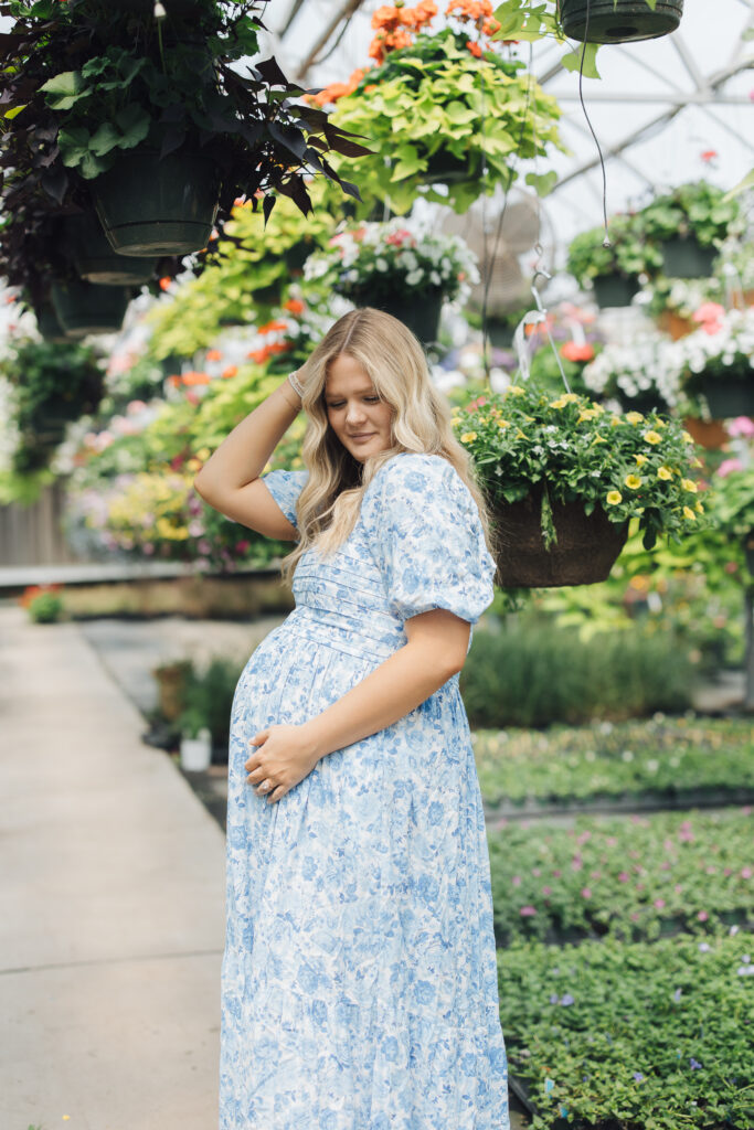 woman smiles at maternity photoshoot in spring