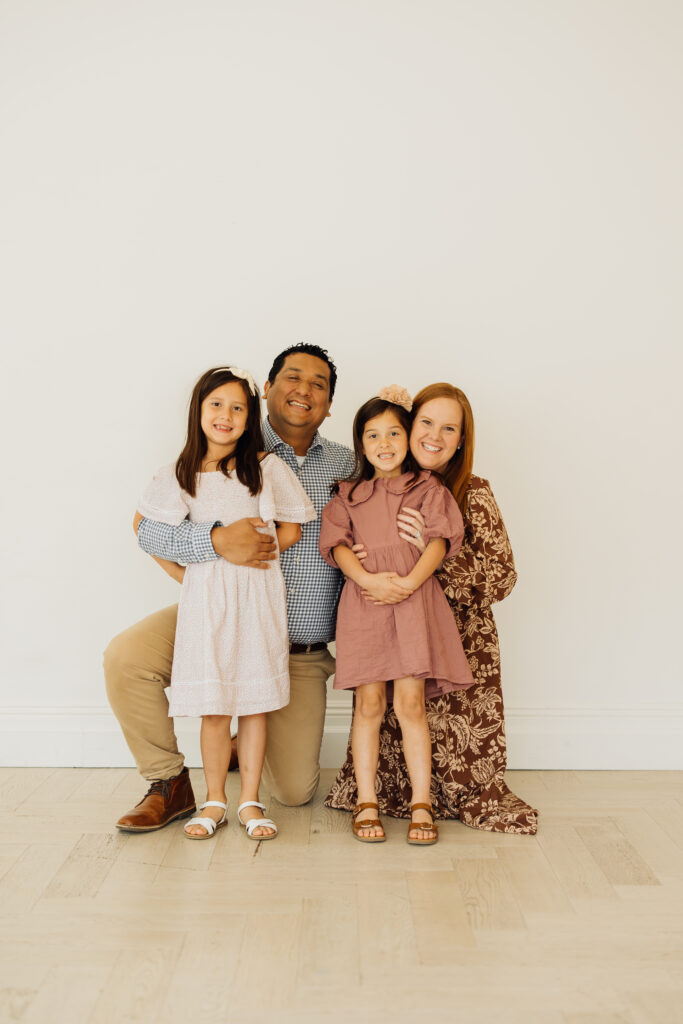 Family smiles at their family session at White Space Studios in Sandy, Utah