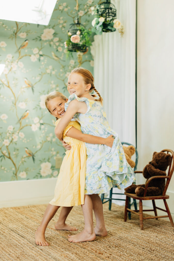 Two sisters smile in the Attic of Brightwood Home Studios 