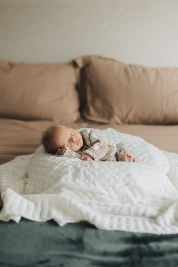 Baby sleeps peacefully in lifestyle newborn session in Saratoga Springs