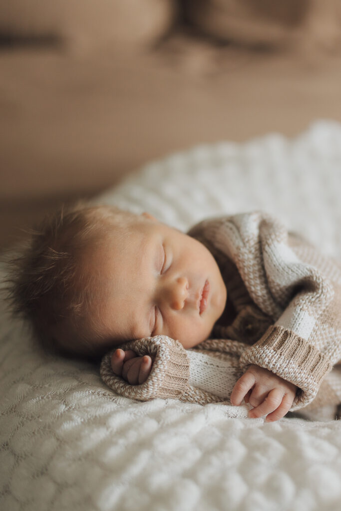 Baby sleeps peacefully in lifestyle newborn session in Saratoga Springs