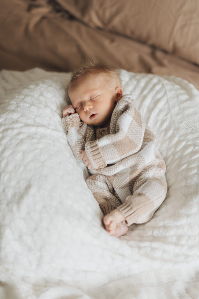 Baby sleeps peacefully in lifestyle newborn session in Saratoga Springs