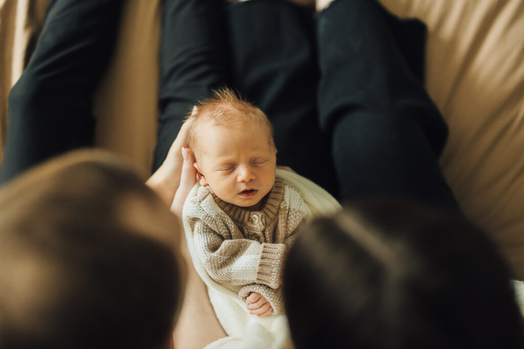 Baby sleeps peacefully in lifestyle newborn session in Saratoga Springs
