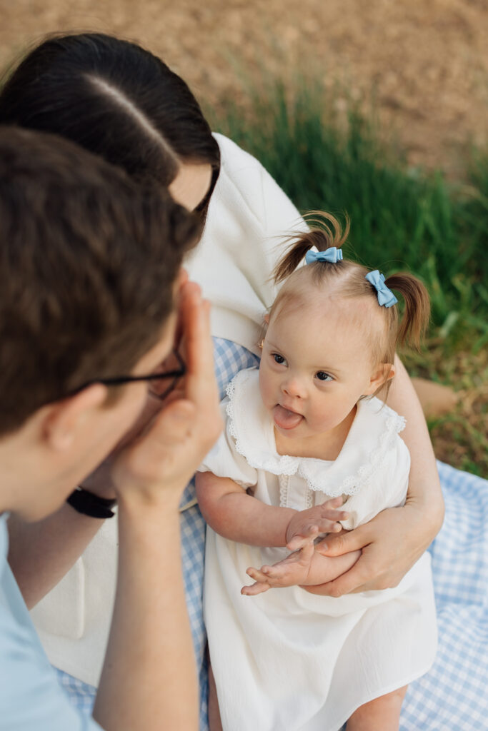 Family plays in spring orchard photo session