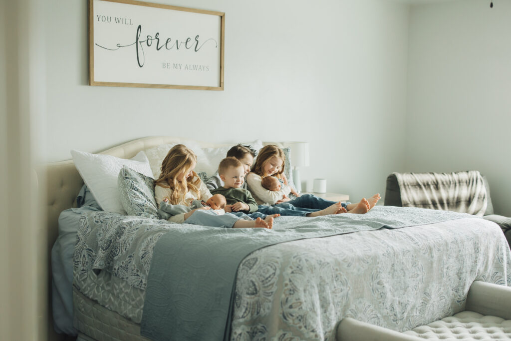 siblings pose with their new baby brothers in twin lifestyle session in Spanish Fork, UT. 