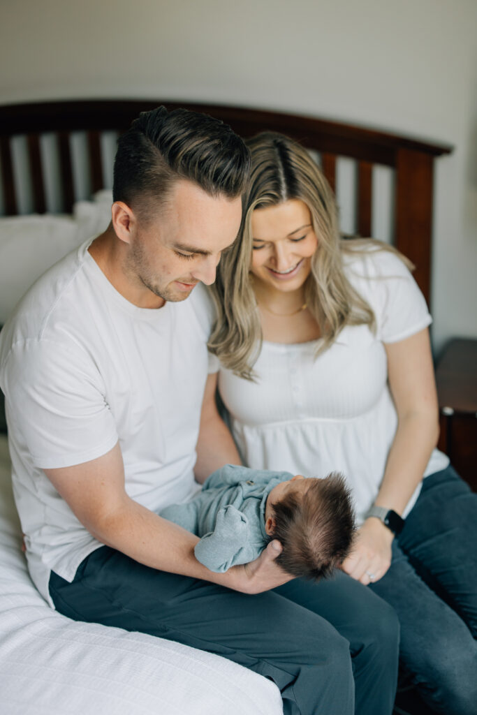 pleasant grove dad and mom smile at newborn son